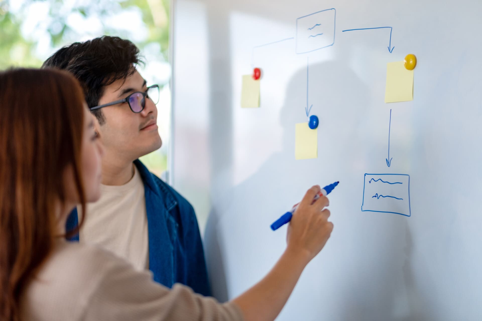 Group of business people looking and discussing ideas over white
