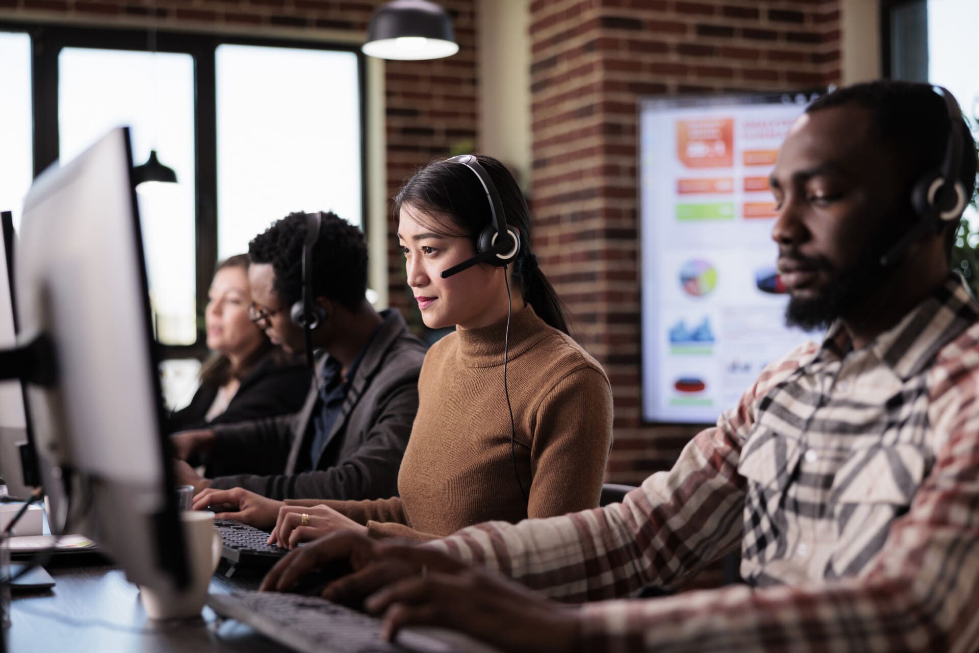 Asian operator working as sales assistant at call center service